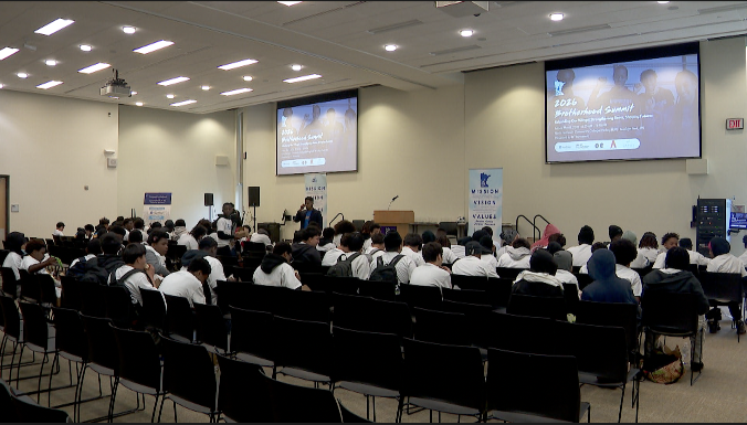 students packed into an auditorium for the improve your tomorrow brotherhood summit