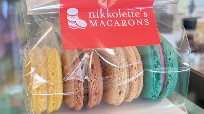 four macarons in a package with the label Nikkolette's Macarons