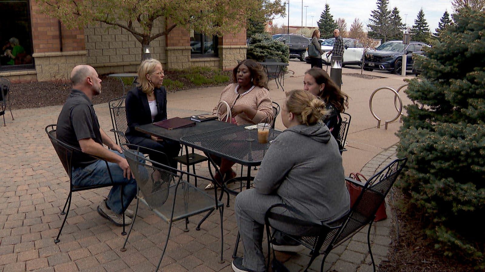 People sitting in a circle with rep. Kelly Morrison