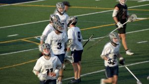 Champlin Park boys lacrosse celebrates a goal versus Anoka