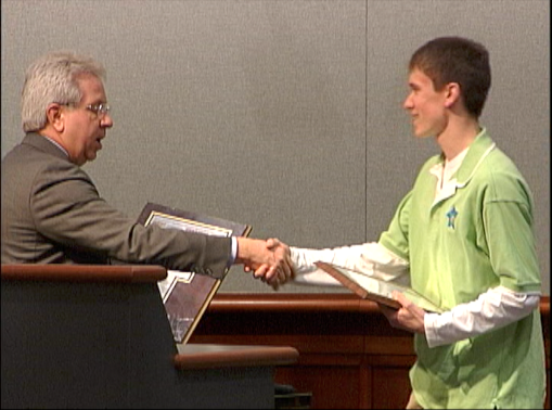 steve lampi shakes the hand of matt norris