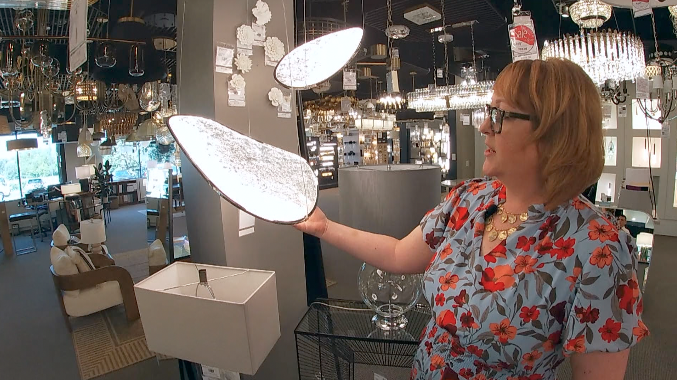 kyndra flowers of robinson lighting shows off an LED light fixture