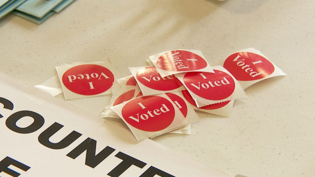 a stack of red 'i voted' stickers