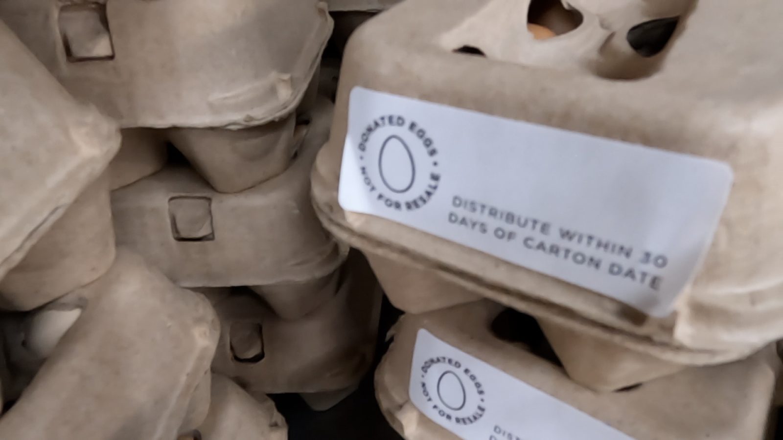 egg carton with a sticker on it that says "donated eggs, not for resale. distribute within 30 days of carton date."